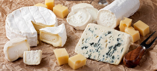 Variety of different cheese. Camembert, goat cheese, roquefort, gorgonzolla, gauda,