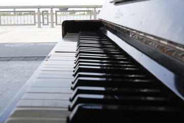 Closeup of antique piano keys and wood grain with sepia tone