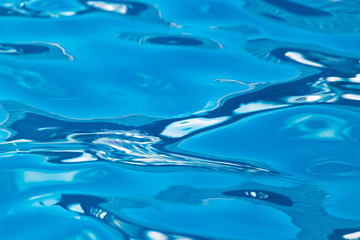 Naklejka na ściany i meble The smooth water in the pool as a background