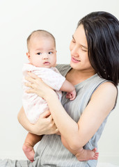 Portrait of happy asian mother hugging her cute baby