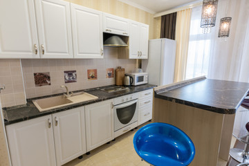 Interior of a one-room apartment, view of a kitchen set