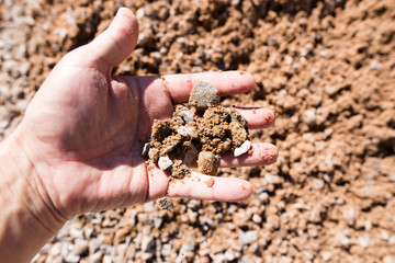 Building crushed stone with sand in hand
