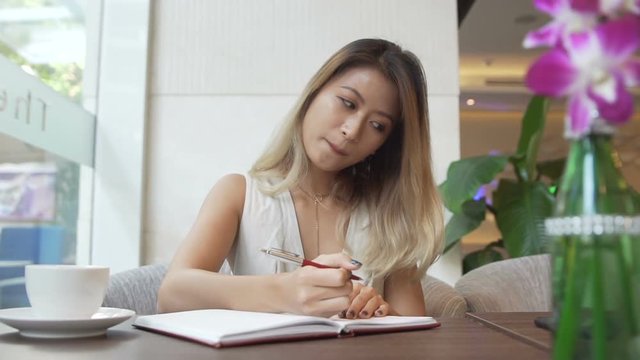 Woman writing in journal, diary