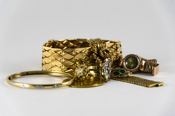 luxurious and expensive golden bracletes, rings and coin. Luxury Jewellery
