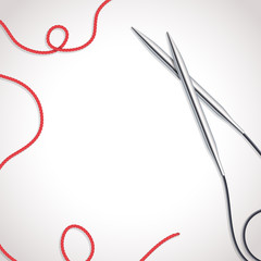 Metallic knitting needles background with yarn