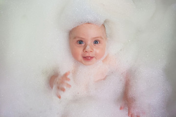 baby in foam in bathroom