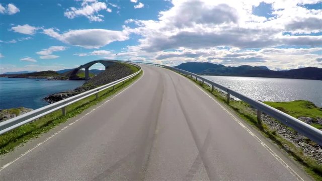 Driving a Car on a Road in Norway Atlantic Ocean Road or the Atlantic Road (Atlanterhavsveien) been awarded the title as (Norwegian Construction of the Century).