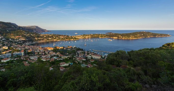 Villefranche-sur-Mer, Saint-Jean-Cap-Ferrat and the Espalmador Bay with yachts and tourist boats in summer (unset to twilight time-lapse). Cote d'Azur, French Riviera, Alpes Maritimes, PACA, France