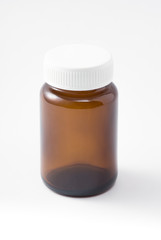 empty light brown medical bottle with white plastic lid have some scratch on white background