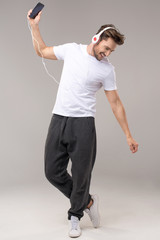 Happy young man with headphones. Listening music