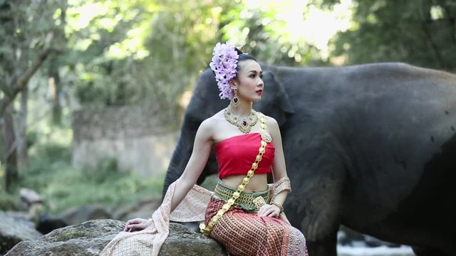 Asian woman with elephant in creek ,Chiang mai Thailand.