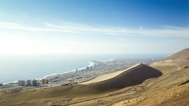 Timelapse of the Iquique skyline with desert and huge dune, Chile.