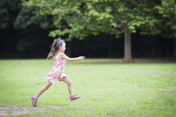 Fototapeta na wymiar Little girl playing in the park