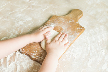 Children's hands make dough