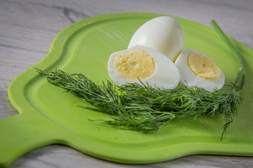 boiled egg and dill on cutting board