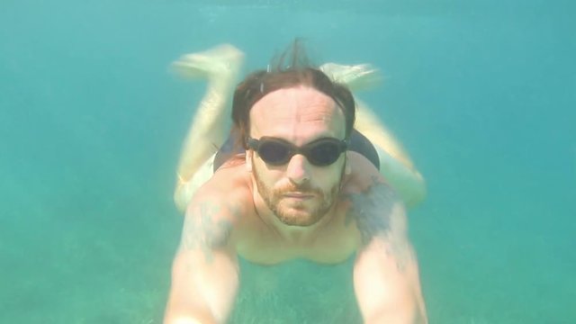 Man diving on a breath hold in a tropical sea, underwater view