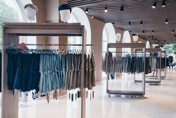 interior of clothing store. On the hangers of sweaters, shirts, dresses.