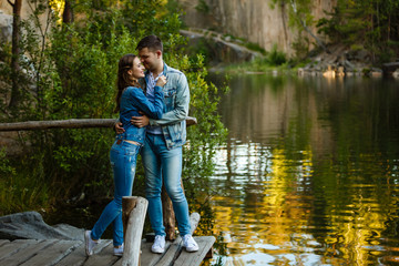 beautiful couple hugging each other near a mountain river