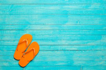 flip-flops on color wooden background