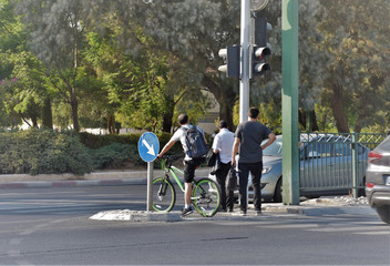 man are waiting on the triffic light