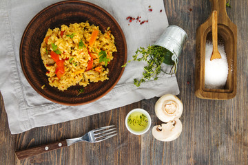 Vegetarian paella, salt, thyme herb, champignons, oil, spice on wooden table. Top view.