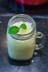 Glass of lemon lime blended summer drink with mint topping