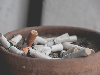 Cigarette butts in the brown pot, anti smoking concept