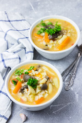 Creamy barley mushroom soup with vegetables and garlic. Spicy, winter comfort food. Selective focus, close up.
