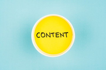 Content word on paper cup. Up view. Content marketing concept