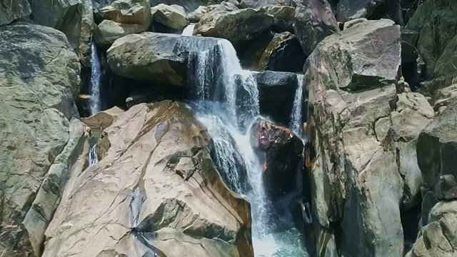 Drone Shows Fantastic Waterfall Flowing on Rocks into Lake