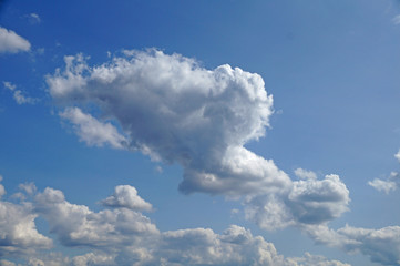 Fluffy white clouds on a blue sky.