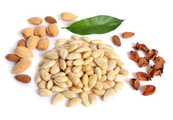 Blanched almonds  with unshelled nuts. On white background.