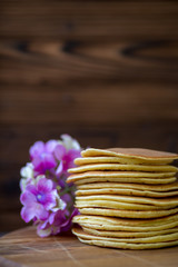 Fototapeta na wymiar Tasty homemade pancakes with cream and raspberry. On wooden table. Village kitchen