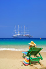 Woman sitting on a chair at the beach
