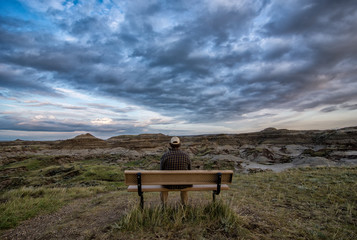 Man Sitting on Bench in the Alberta Badlands Dinosaur Provincial Park