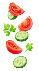 Isolated vegetables. Mixed slices of cucumber and tomato floating in the air isolated on white with clipping path
