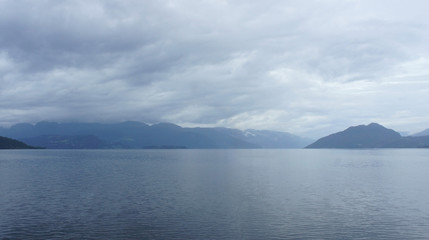 Silhouette of hills, view from the ferry, cloudy weather, Norway, Scandinavian landscape