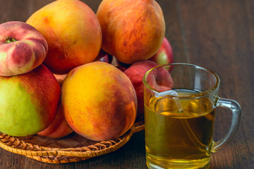 Still life of peaches and juice on a dark background