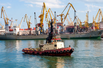 Naklejka premium Cargo ship in the Black Sea in Odessa. Boat to dock for transportation. 24-08-2017