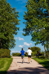 Two young men running in the park
