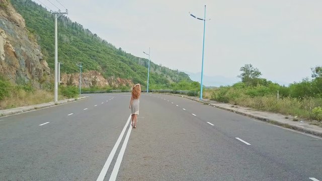 Close View Girl Straights Hair Walks along Traffic Strip