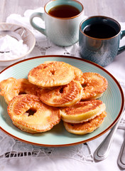 Apple fritters on blue plate