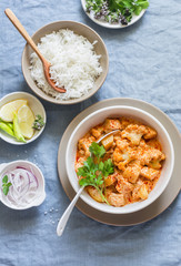 Cauliflower, potato curry and rice. Delicious vegetarian lunch, on a blue background, top view