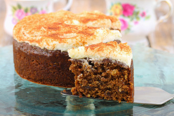 Slice of delicious carrot cake with walnuts with marzipan icing
