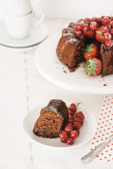 Chocolate cake with fresh berries set in a white tableware