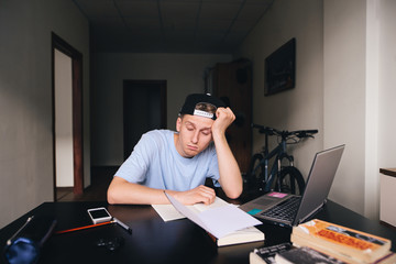 The midwife fell asleep at the table in his room while studying at home. Homework.