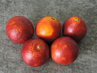 Red oranges on a gray background. Top view. Copy space.