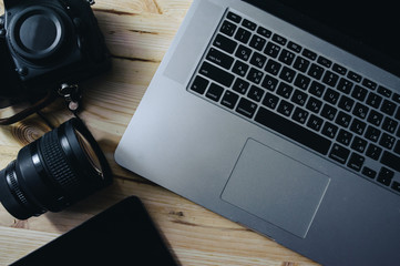 Digital time. Busines devises. Photo equipment. Top view of diverse personal equipment for photographer laying on the wooden grain
