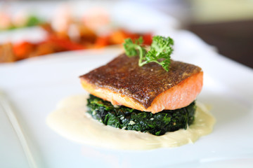 Grilled salmon steak on white plate