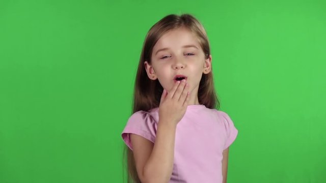 Baby sends kisses to everyone. Green screen. Slow motion